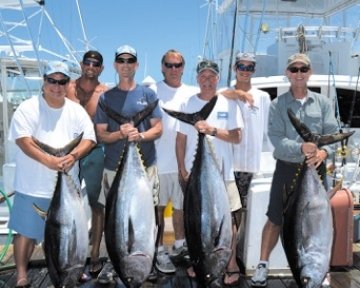 group of men posing with caught tuna